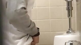 Sexy chav shaking his cock in the urinals